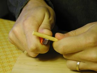 Roll the cane segment against the knife